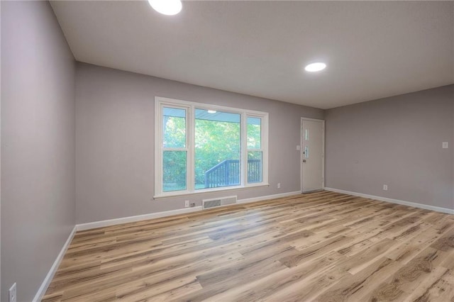 spare room featuring light hardwood / wood-style flooring