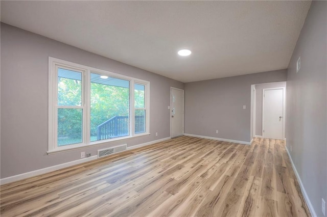 unfurnished room featuring light hardwood / wood-style floors