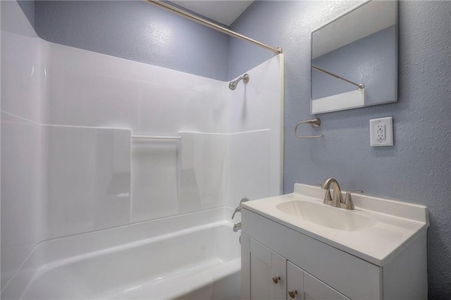 bathroom with vanity and washtub / shower combination