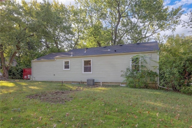 back of house featuring a yard and cooling unit