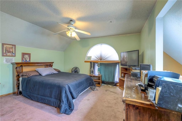 bedroom with a textured ceiling, ceiling fan, carpet, and lofted ceiling