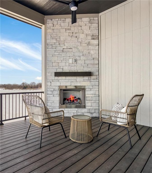 16781 S Fellows St, Olathe, KS 66062 - wooden deck with an outdoor stone fireplace and a ceiling fan