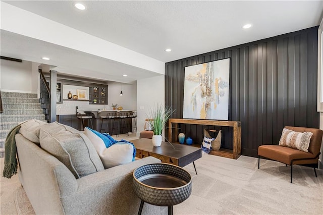 16781 S Fellows St, Olathe, KS 66062 - carpeted living room featuring recessed lighting, stairway, and wet bar
