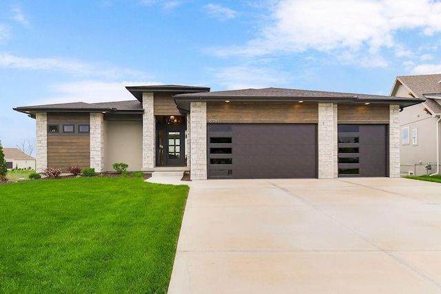 16781 S Fellows St, Olathe, KS 66062 - view of front of house featuring a garage, stone siding, concrete driveway, a front yard, and roof with shingles