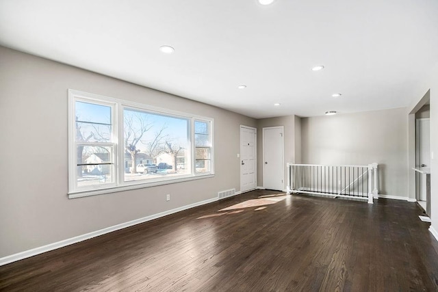 spare room with dark hardwood / wood-style flooring