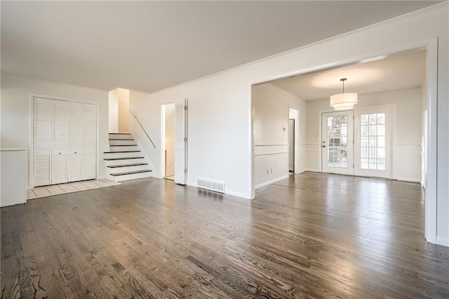 unfurnished living room with dark wood-type flooring