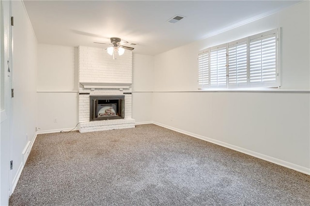 unfurnished living room featuring ceiling fan, carpet floors, and a fireplace