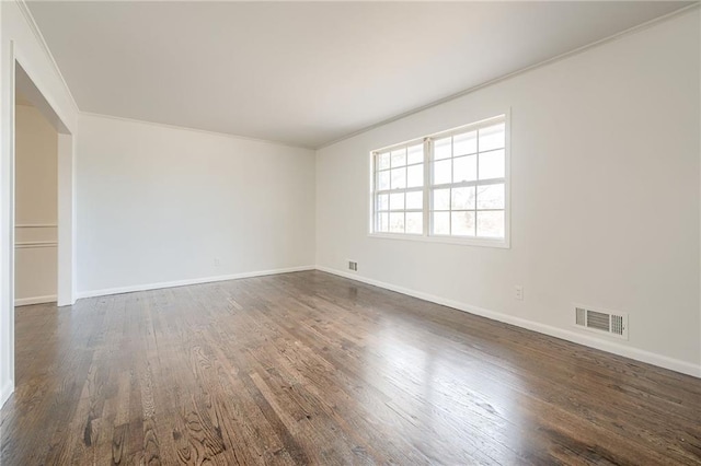 unfurnished room with dark hardwood / wood-style floors and crown molding