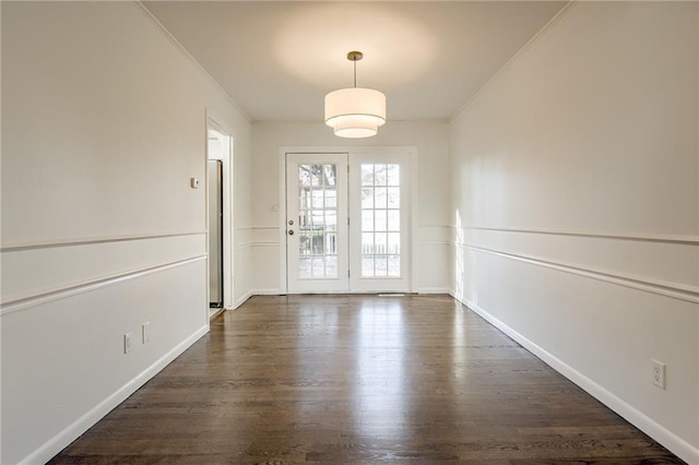 interior space with ornamental molding and dark wood-type flooring