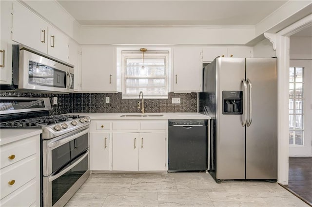 kitchen featuring backsplash, stainless steel appliances, white cabinetry, and sink