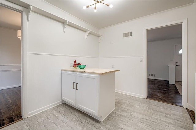 interior space featuring light hardwood / wood-style flooring and a notable chandelier