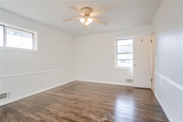 unfurnished room featuring a wealth of natural light, ceiling fan, and dark hardwood / wood-style floors