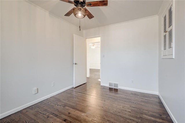 spare room featuring dark hardwood / wood-style floors, ceiling fan, and ornamental molding