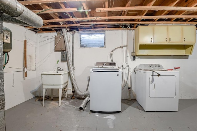 laundry area with cabinets, independent washer and dryer, and sink