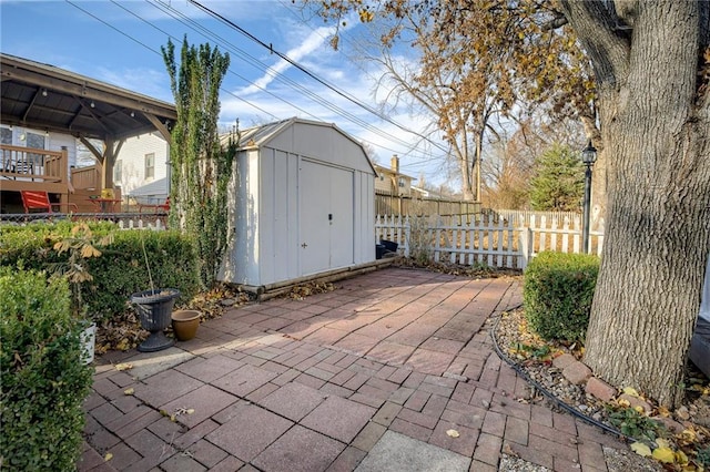 view of patio / terrace with a gazebo and a storage shed