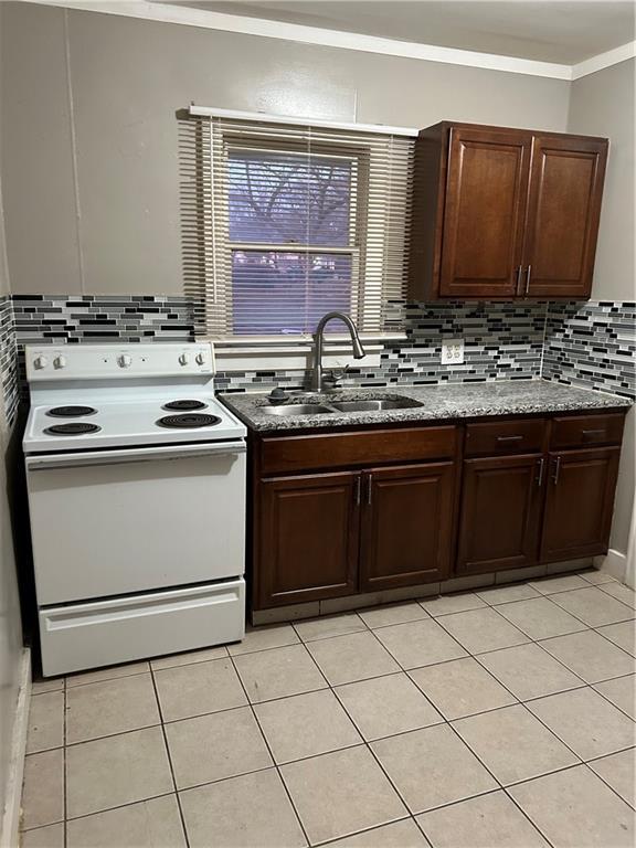 kitchen featuring tasteful backsplash, sink, stone countertops, white electric stove, and light tile patterned flooring