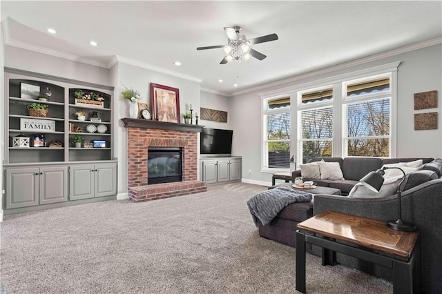 living room featuring ceiling fan, ornamental molding, a fireplace, and carpet floors