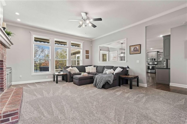 carpeted living room featuring crown molding, ceiling fan, and a fireplace