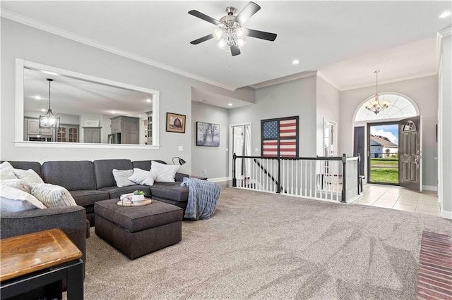 living room with crown molding, light colored carpet, and ceiling fan with notable chandelier