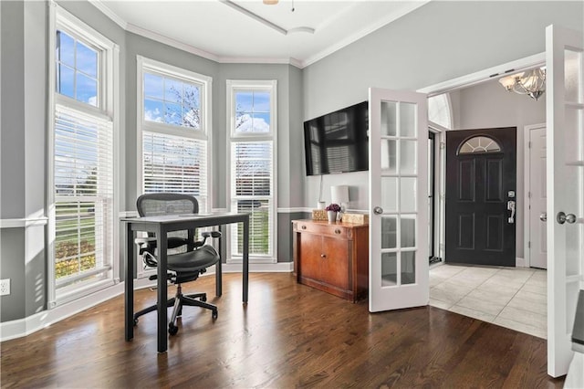 office featuring hardwood / wood-style flooring, ornamental molding, a chandelier, and french doors