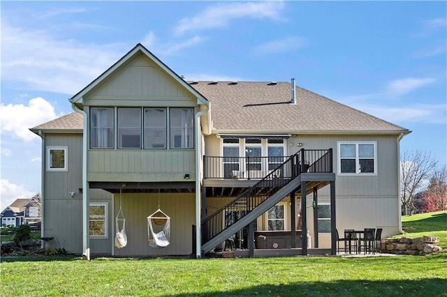 back of house featuring a wooden deck and a yard