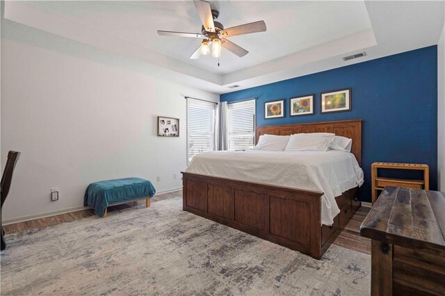 bedroom with ceiling fan and light wood-type flooring