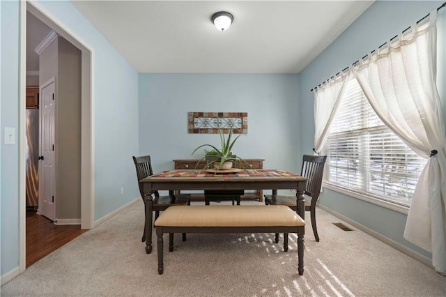 view of carpeted dining area