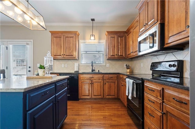 kitchen with pendant lighting, sink, dark stone countertops, black appliances, and crown molding