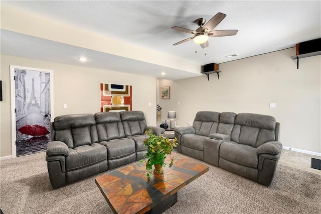 carpeted living room featuring a textured ceiling and ceiling fan