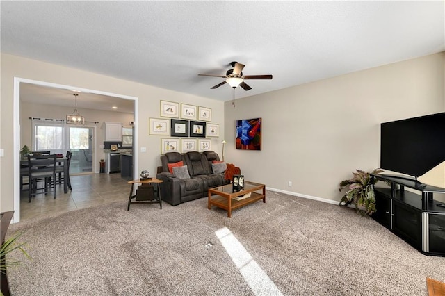 living room featuring carpet and ceiling fan