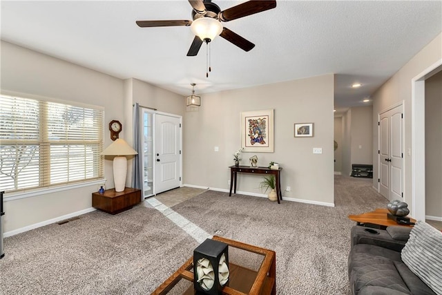 living room featuring ceiling fan and light colored carpet