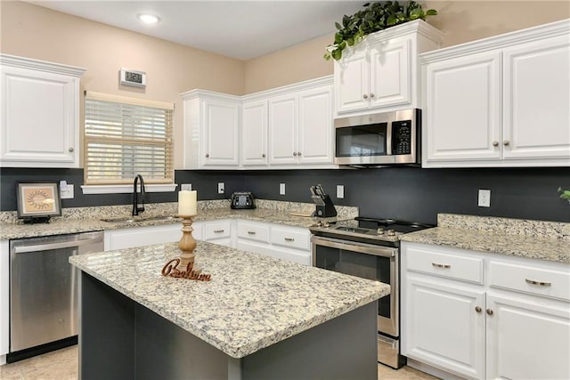 kitchen with sink, white cabinetry, a center island, and stainless steel appliances