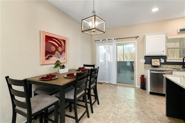 dining area with sink, light tile patterned floors, and a chandelier