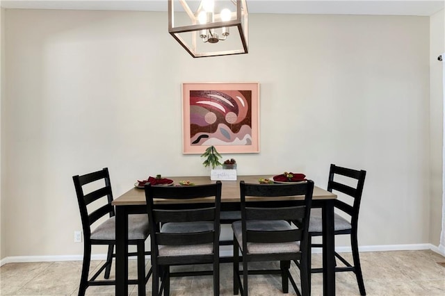 dining area with light tile patterned flooring and an inviting chandelier