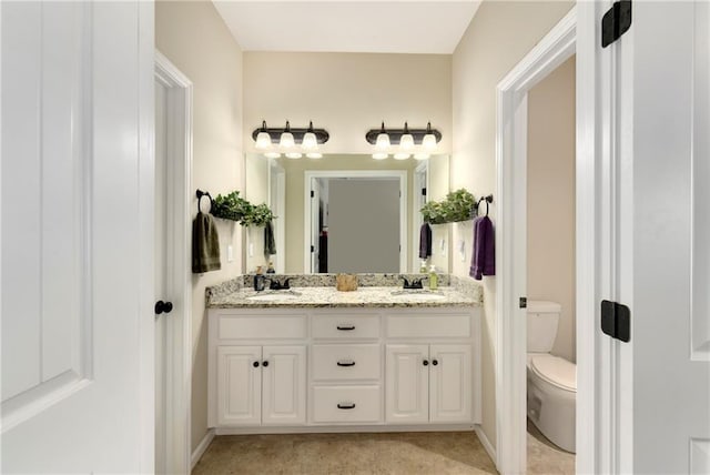 bathroom with toilet and vanity