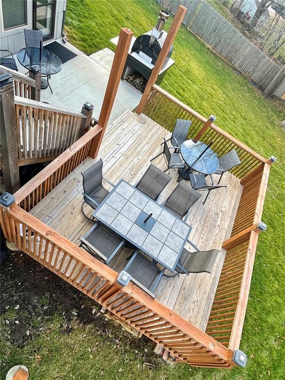 wooden terrace with a lawn