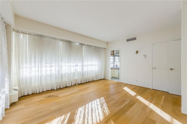 spare room with hardwood / wood-style floors