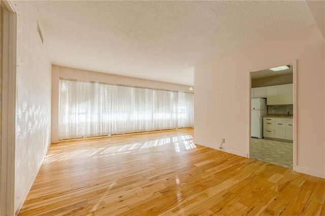 unfurnished room with light wood-type flooring