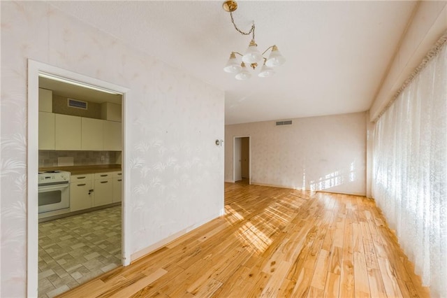 interior space featuring hardwood / wood-style floors and a notable chandelier