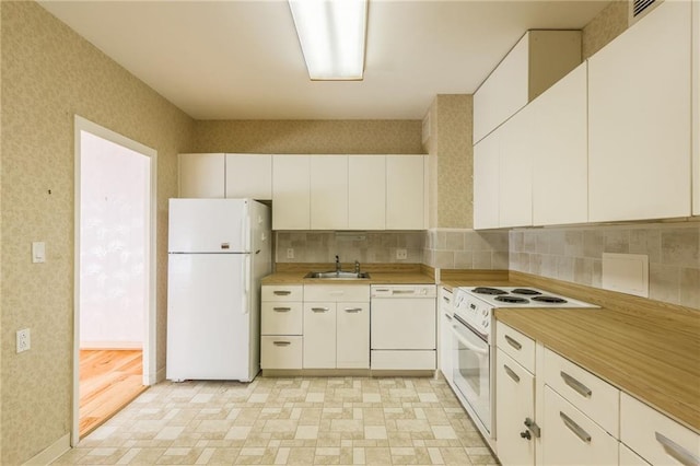 kitchen featuring white cabinetry, sink, white appliances, and decorative backsplash