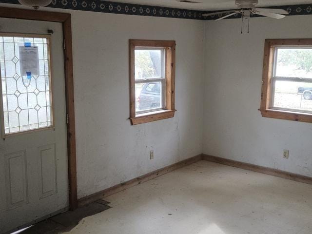 entryway with concrete flooring, a wealth of natural light, and ceiling fan