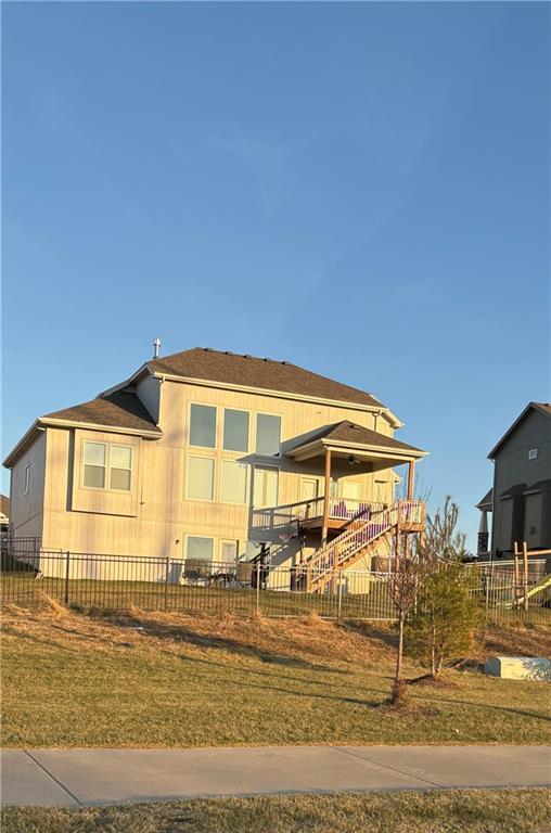 rear view of house with a yard