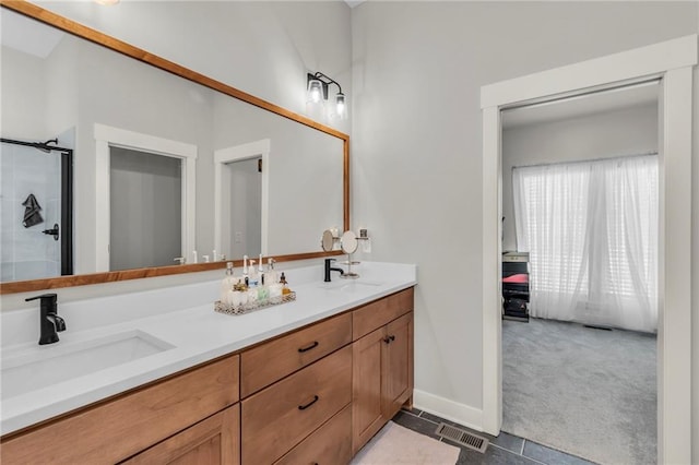 bathroom with tile patterned flooring, vanity, and walk in shower