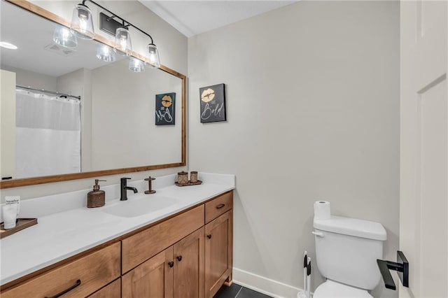 bathroom with tile patterned flooring, vanity, and toilet