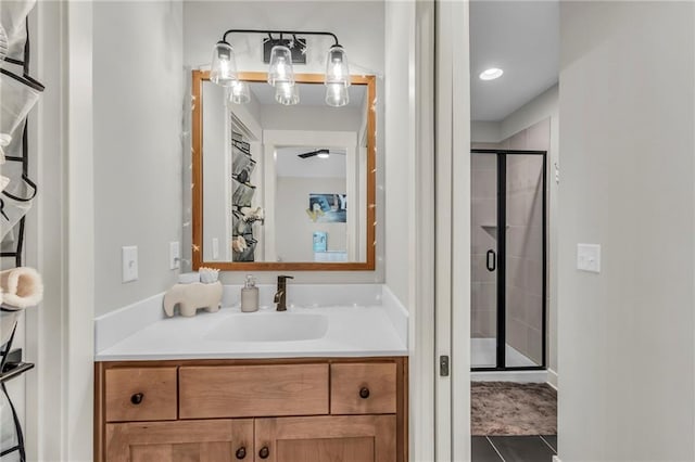 bathroom with tile patterned flooring, vanity, and a shower with door