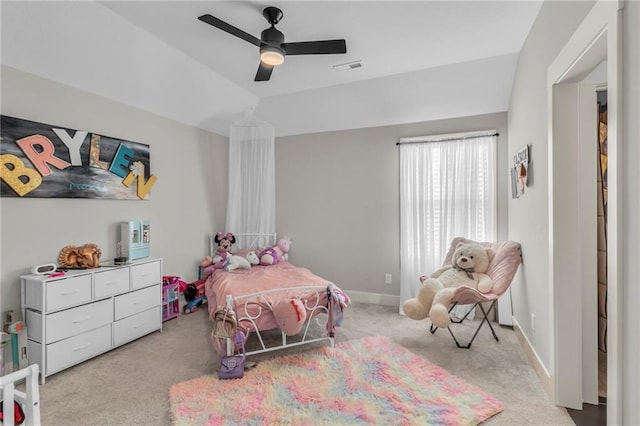 bedroom featuring light colored carpet, visible vents, vaulted ceiling, ceiling fan, and baseboards