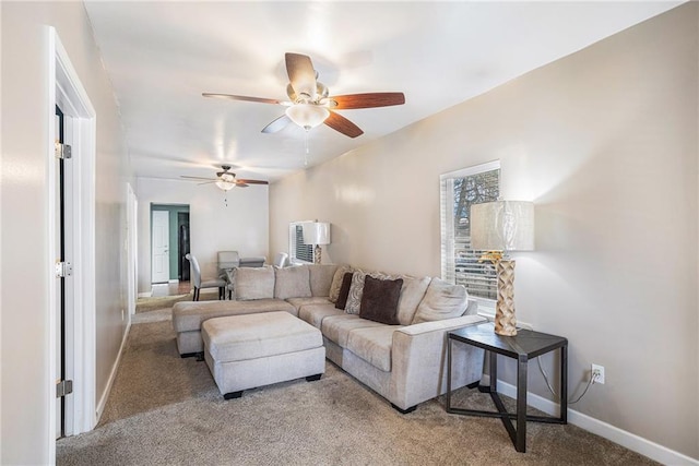 carpeted living room featuring ceiling fan