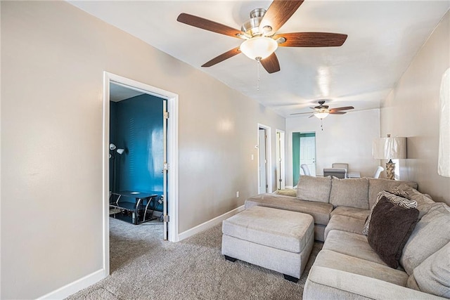 carpeted living room with ceiling fan