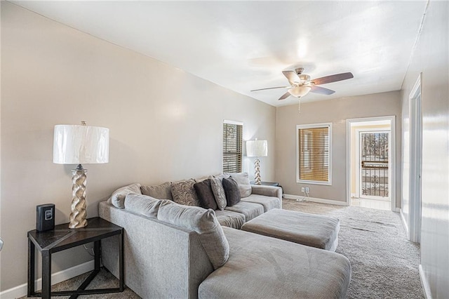 carpeted living room with ceiling fan