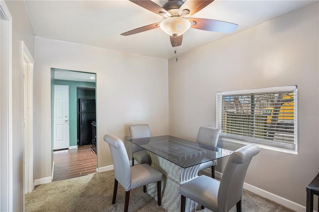 carpeted dining space featuring ceiling fan